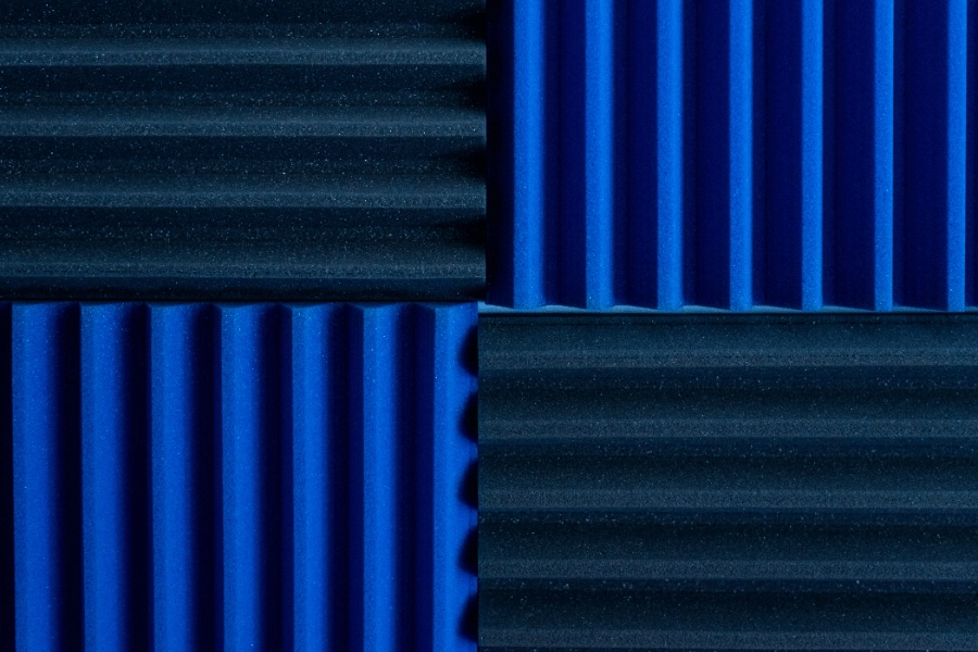 dark blue acoustic panels on a wall to block noise 